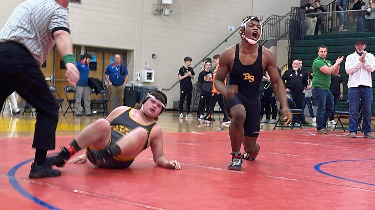 Bryan Station’s Jahvan Frazier celebrated his finals match win by fall over Harrison County’s JD Tucker in the 215-pound class at the Region 6 Wrestling Championships.