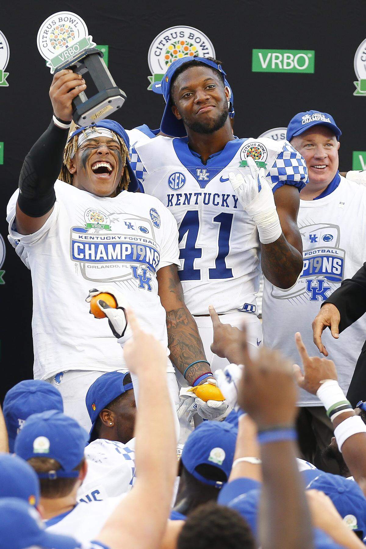 Kentucky stars Benny Snell, left, and Josh Allen (41) and Wildcats head coach Mark Stoops celebrate after UK defeated Penn State 27-24 in the Citrus Bowl that followed the 2018 season.