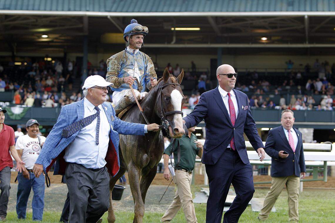 Albaugh Family Stables' Dennis Albaugh, left, and Jason Loutsch led Free Drop Billy and jockey Robby Albarado to the winner's circle after winning the Grade 1 Claiborne Breeders' Futurity at Keeneland last October. Free Drop Billy beat fellow Kentucky Derby hopefuls Bravazo and Lone Sailor that day.