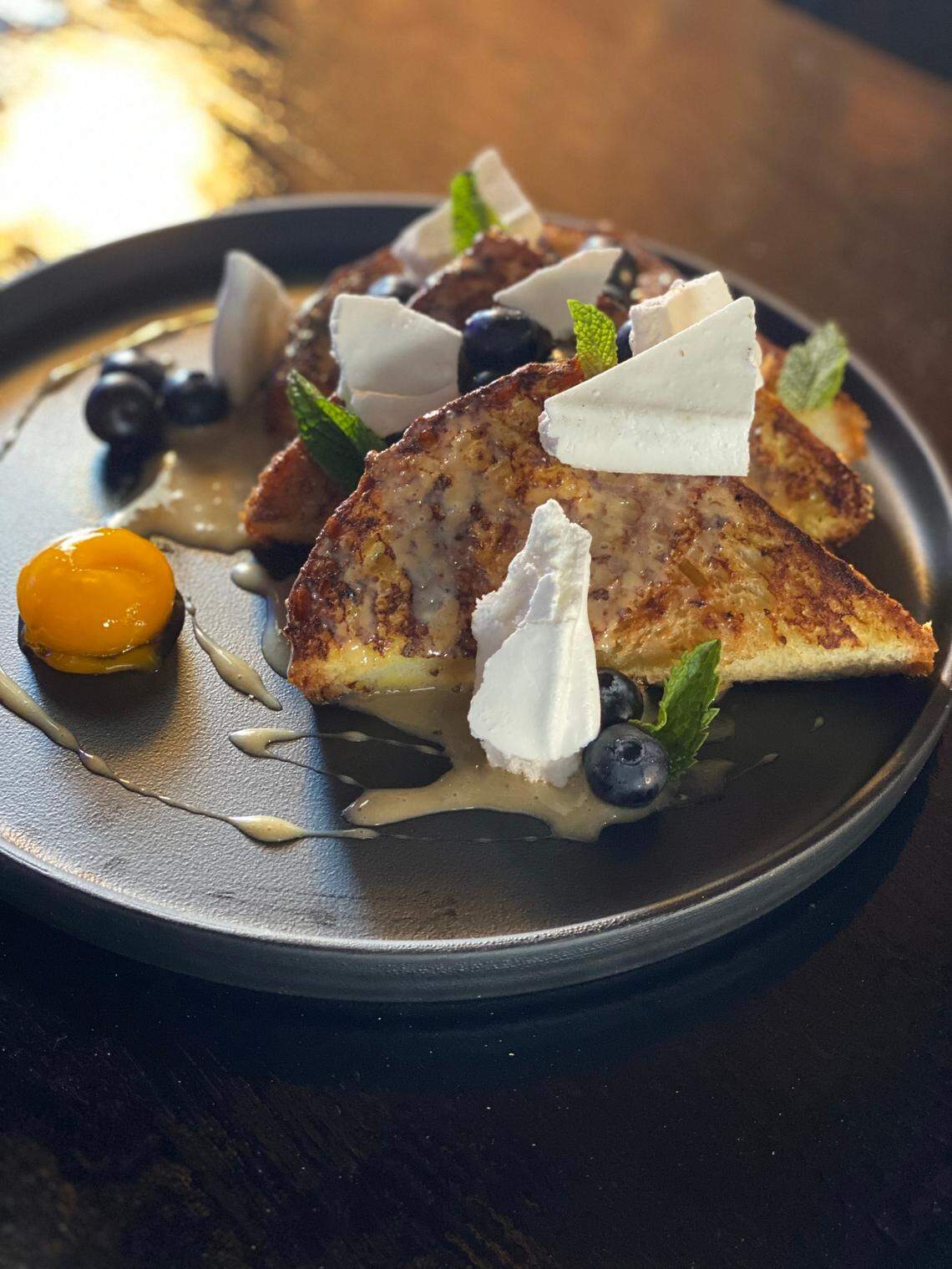 French toast with bourbon salted caramel and blueberries and a cured egg yolk will be on the menu when ELIXIR Downtown opens for brunch Saturday. The new restaurant, bar and live music venue will be opening June 12 with limited seating.