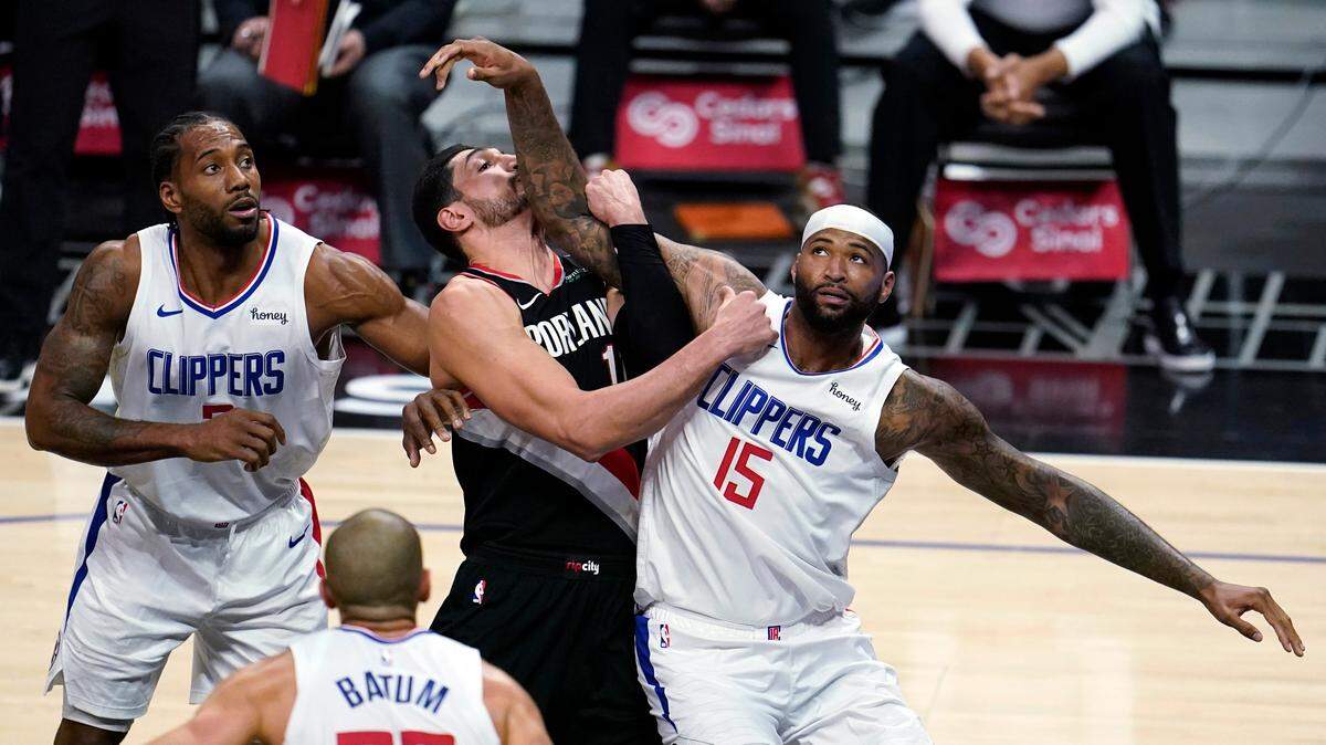 Los Angeles Clippers center DeMarcus Cousins (15) works for position under the basket next to Portland Trail Blazers center Enes Kanter, center, and Clippers’ Kawhi Leonard, left, during the first half of an NBA basketball game Tuesday, April 6, 2021, in Los Angeles. (AP Photo/Marcio Jose Sanchez)