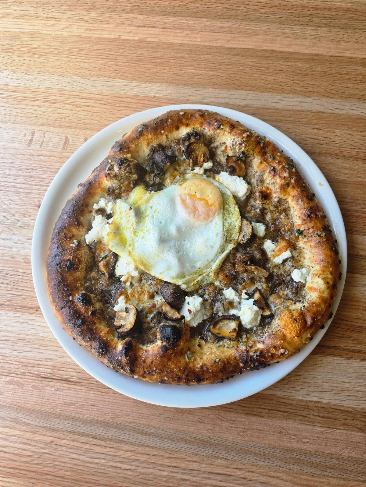 The Funkhi ($19) pizza at Crust is made with porcini, shiitake and cremini mushrooms, ricotta, egg, Parmesan and crushed chili.