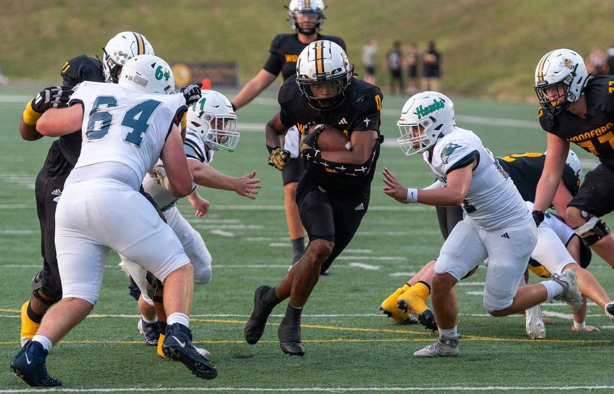 Woodford County’s Darrian Tomlin goes up the middle for a touchdown in the first quarter of a 42-14 win against Great Crossing at Community Stadium in Versailles on Friday.