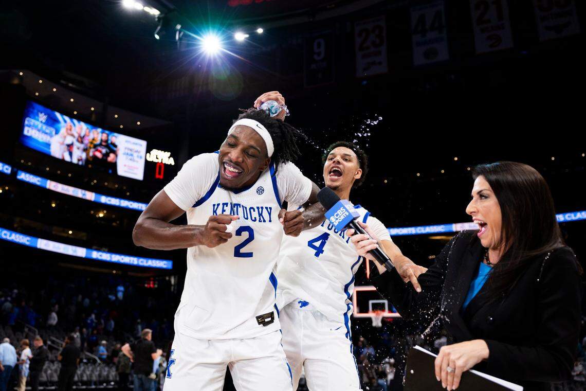 Kentucky’s Tre Mitchell (4) pours a bottle of water over freshman Aaron Bradshaw (2) after the team upset North Carolina 87-83 in the CBS Sports Classic at State Farm Arena in Atlanta.