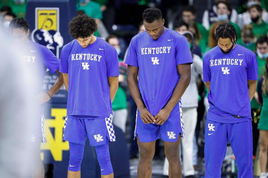 Kentucky’s Dontaie Allen, left, Oscar Tshiebwe and Davion Mintz observed a moment of silence for victims of the deadly tornadoes that swept through the commonwealth before the team’s game against Notre Dame in South Bend, Ind., on Saturday.