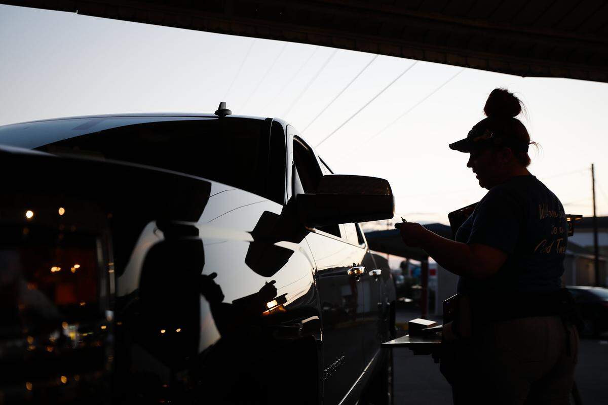 Server Lacey France delivers an order to a customer May 2 at the Parkette Drive-In. The New Circle Road restaurant has actually hired help during the COVID pandemic.