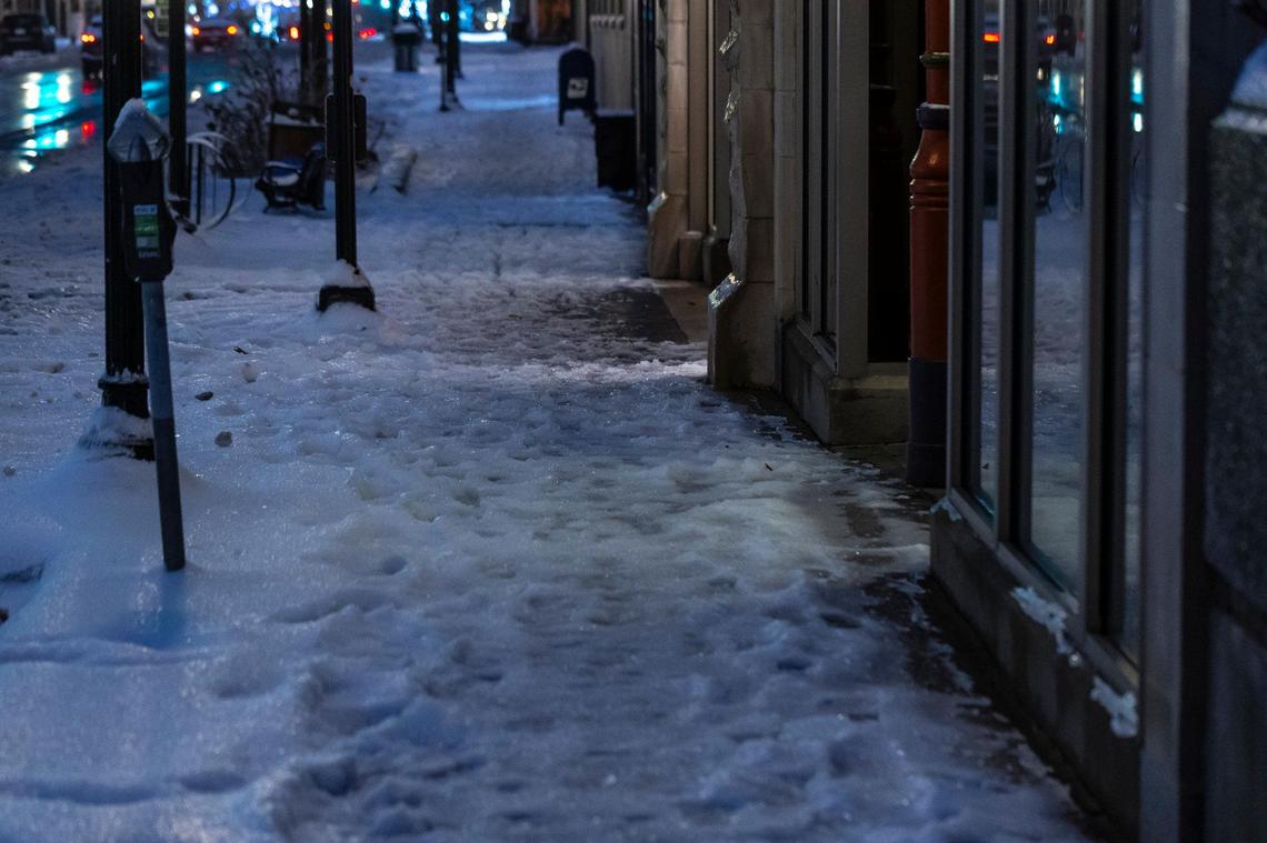 Ice and snow cover a sidewalk in downtown Lexington, Ky., on Monday, Jan. 6, 2025.