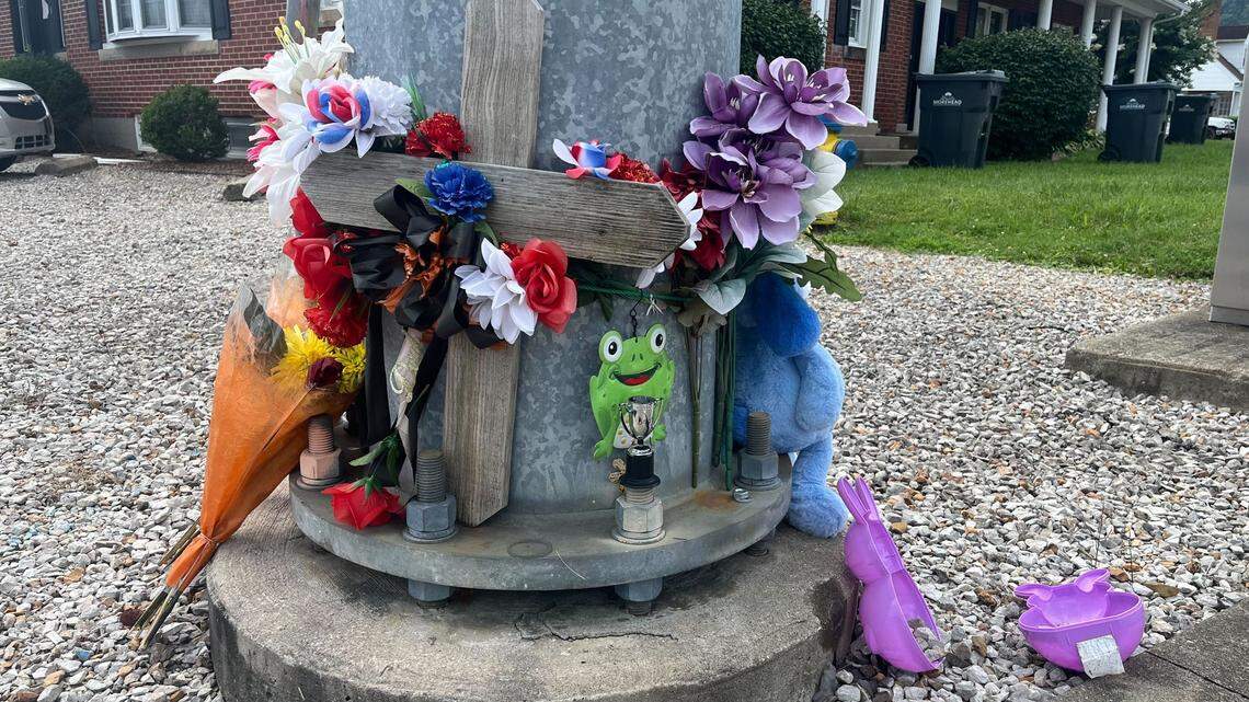 A makeshift memorial has been created outside a Morehead triplex where a 15-year-old boy was shot and killed on July 20, 2025.