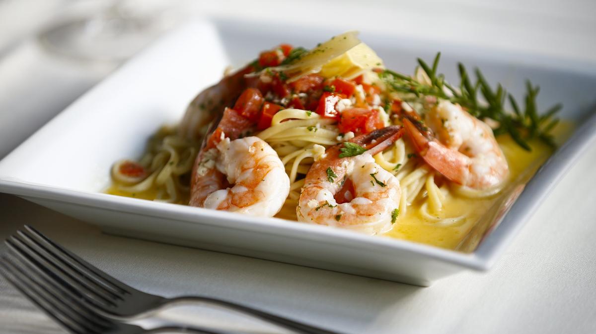 Shrimp scampi with butter, garlic, lemon fresh tomato, basil, and a sprig of rosemary at Portofino in Lexington.