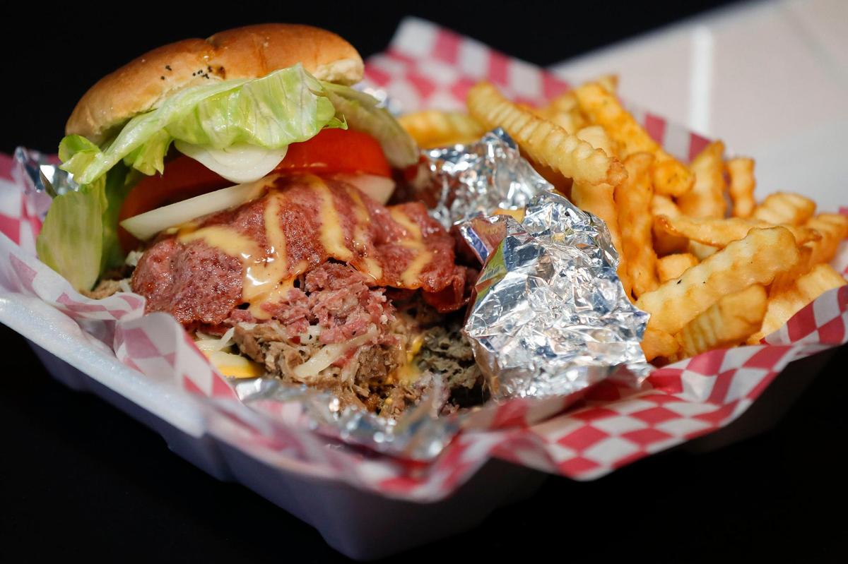 The “Mr. Krab Patty” made with ground chuck, shaved ribeye, shaved corned beef, turkey bacon and topped with lettuce, tomato, onions, pickles and homemade Mr. Krab sauce at Mr. Krabs & Bean’s BBQ in Lexington, Ky., Thursday, Nov. 19. 2020.