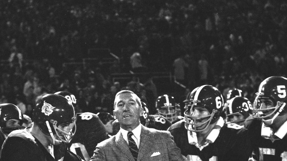Kentucky football players prepared to put Coach Charlie Bradshaw on their shoulders to carry him off the field after UK defeated Auburn 17-7 at Stoll Field/McLean Stadium in Lexington on October 1, 1966. This was the last time Kentucky defeated Auburn at home. Herald-Leader Archive Photo