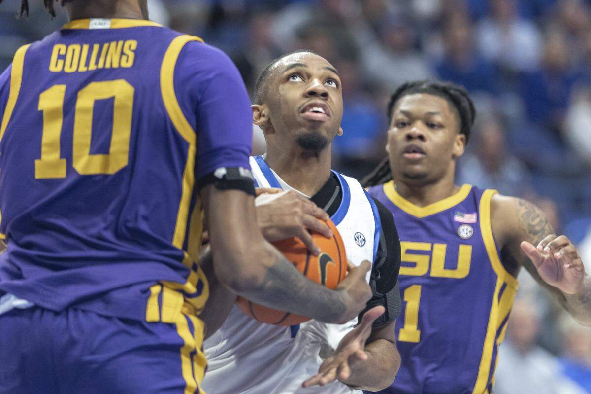 Kentucky guard Lamont Butler, center, looks to move the ball as LSU forward Daimion Collins and guard Jordan Sears defend during a game at Rupp Arena on March 4.