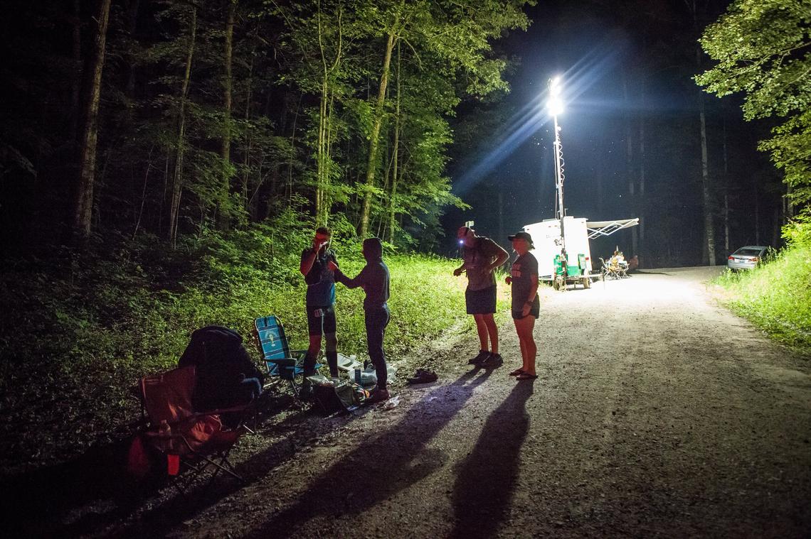 Dustin Mitchell met his crew at aid station S Tree at mile 75 around midnight Saturday in the War Hammer 100 Mile Endurance Run. Due to his early fast pace and the affect of the wet conditions on his feet, Mitchell was being over taken by other runners, eventually dropping out at mile 80.