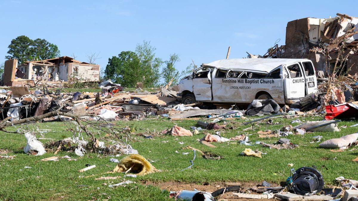 The Sunshine Hill Baptist Church bus sits destroyed among neighboring houses in the Sunshine Hills neighborhood, Sunday, May 18, 2025 in London, Ky. Two days earlier, a deadly tornado ripped through the neighborhood destroying homes.