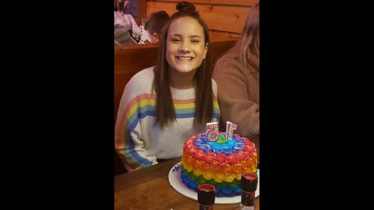 Kayla Kenney posed with a rainbow cake on her 15th birthday. Her family said she was expelled from her Christian school in Louisville because of the photo.