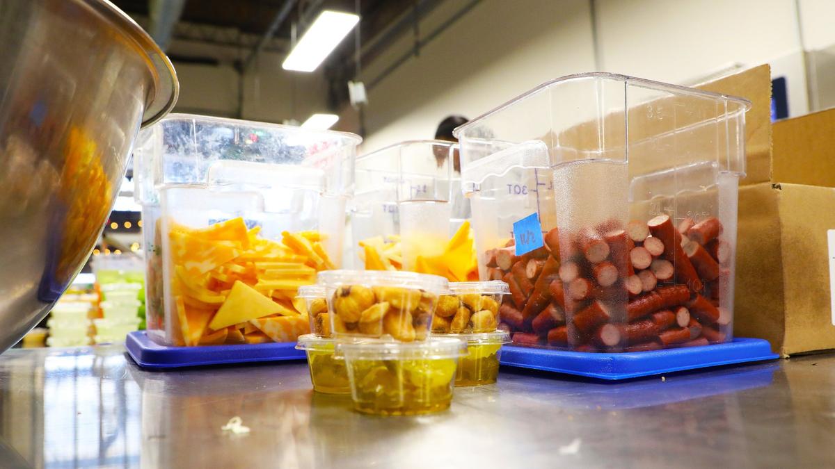 Additional snacks such as jerky bites, pickles, and cheese wedges are added to nutritious pre-packed school lunches customized to each student’s needs through “Packed,” a new venture from FoodChain founder Becca Self, on December 3, 2024, in Lexington, Ky.