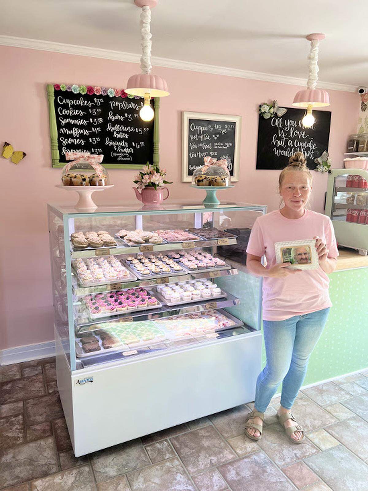 Owner Ashley Crossen with a photo of her great-grandmother Olive, for whom the bakery is named.