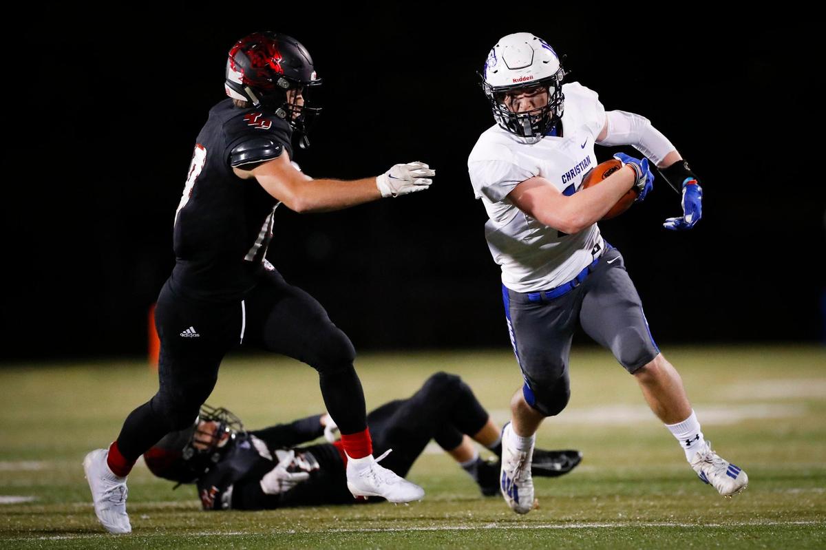 Lexington Christian’s Mason Moore (16) carried the ball past Paul Laurence Dunbar’s Brent Angel (19) and Weston Holloman (24) during Thursday night’s win.