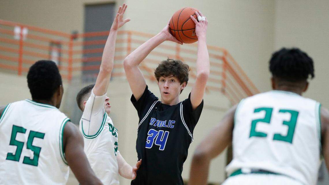 Lexington Catholic’s Reece Potter looks to pass the ball in a game against Paul Laurence Dunbar during the 2020-21 season.