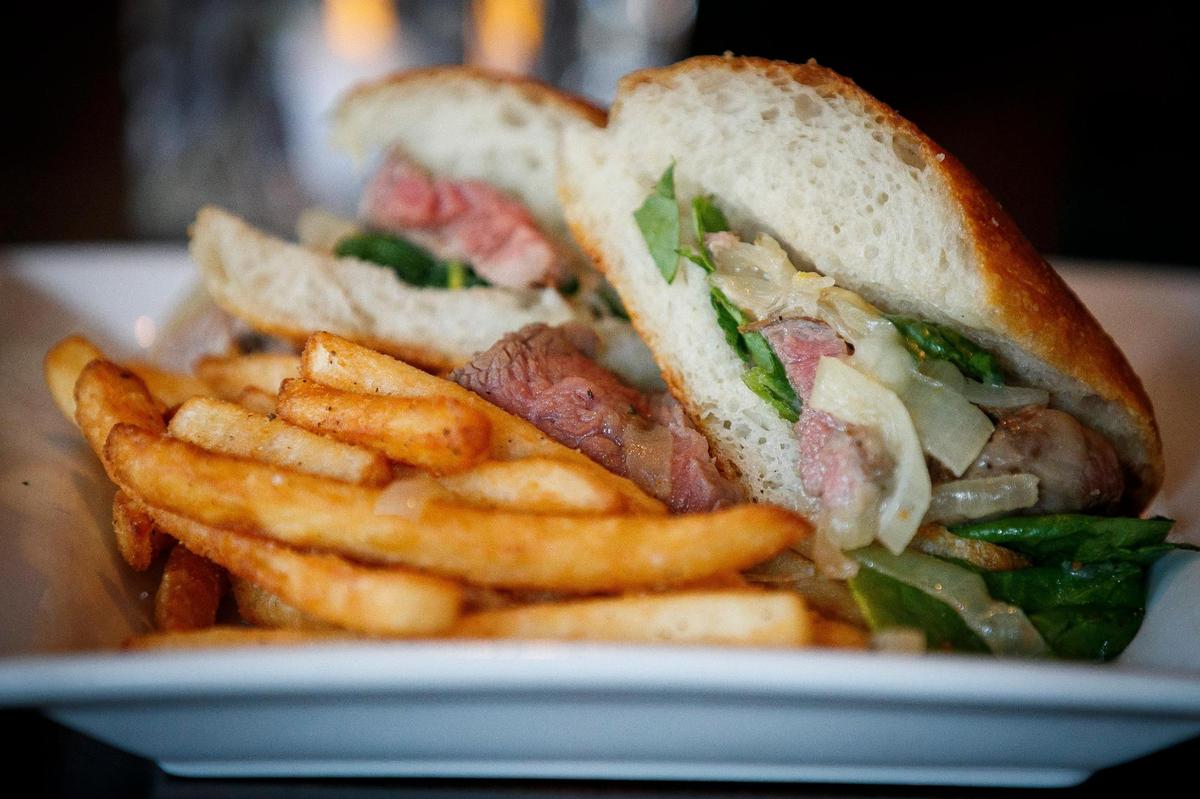 The Steak Hero with grill roasted bistro steak, mozzarella, horseradish aioli, spinach, cartelized onions and served with fries at The Goose of Lexington in Lexington, Ky., Wednesday, May 5, 2021.