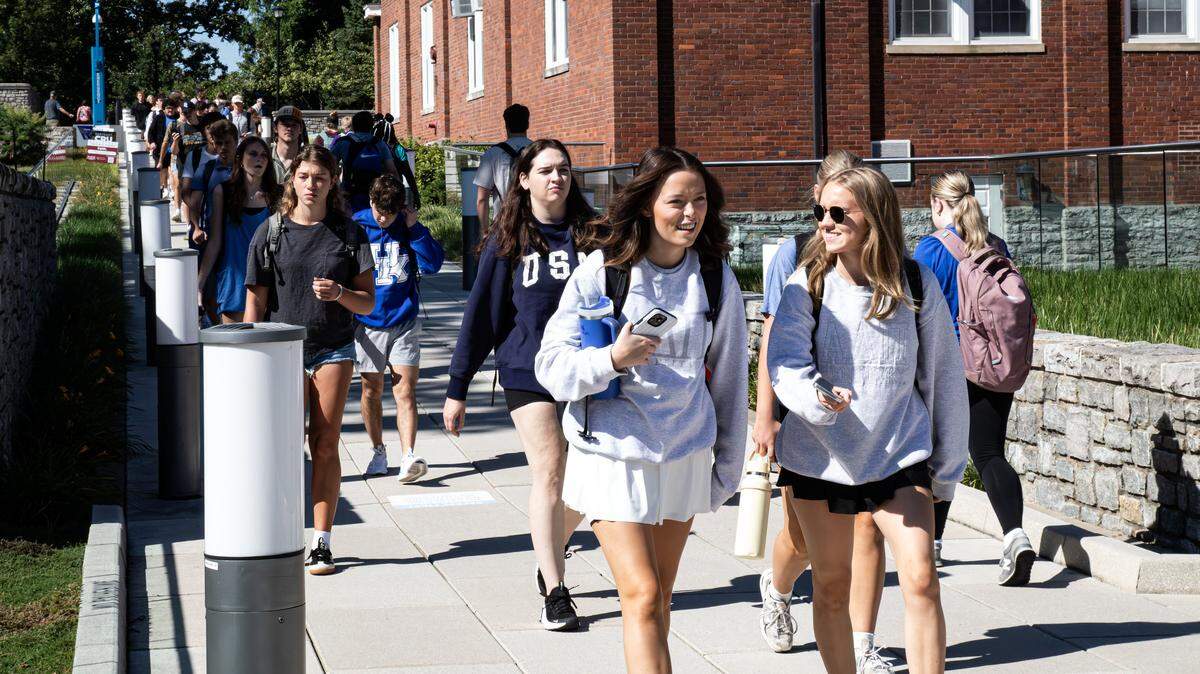 Students using the pedestrian bridge crossing connected to the UK Gatton Student Center during UK's first day of the fall semester on August 25, 2025, in Lexington, Ky. 