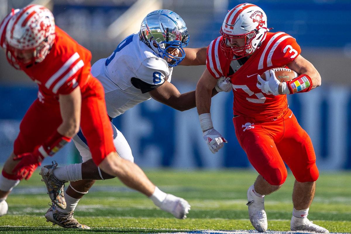 Belfry’s Isaac Dixon (3) runs past Paducah Tilghman’s Chris Allen during the Class 3A championship game at Kroger Field on Dec. 4.