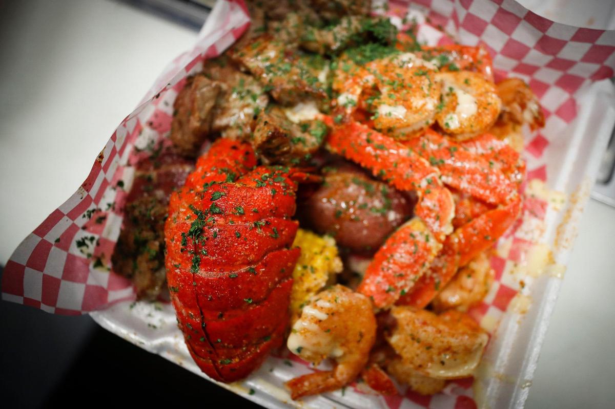 The “Boss Platter” consisting of a lobster tail, grilled shrimp, steak bites, smoked corn, smoked potatoes, smoked sausage, and a smoked egg at Mr. Krabs & Bean’s BBQ in Lexington.
