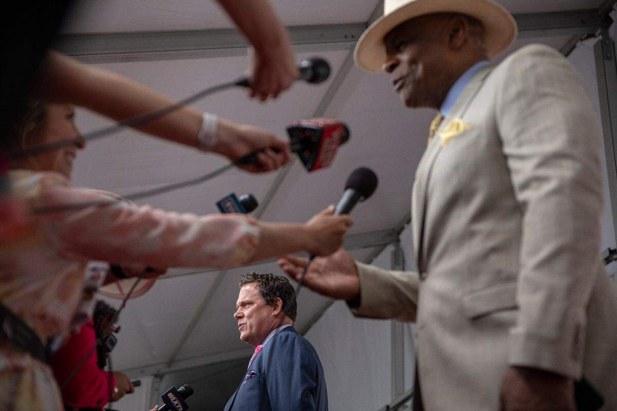 Bachelor star Bob Guiney, left, and Warren Moon talk with reporters on the red carpet at Churchill Downs before the start of 149th Kentucky Derby in Louisville, Kentucky on Saturday, May 6, 2023.