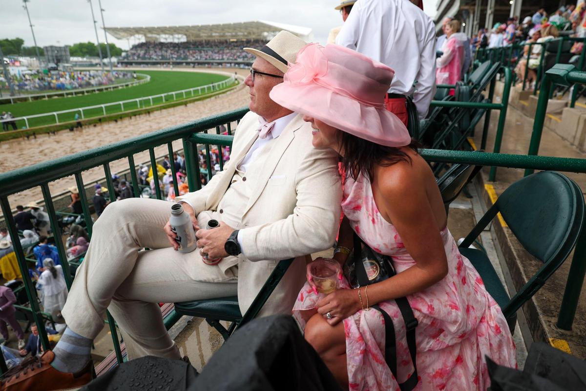Michael and Heather Payne enjoy a few dry minutes during Kentucky Derby 151 at Churchill Downs May 3, 2025.&nbsp;&nbsp;
