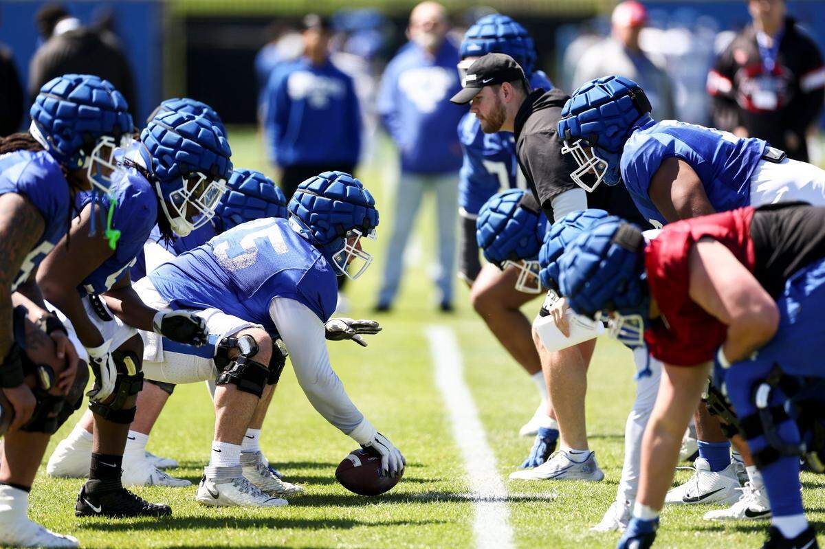 The Kentucky football offensive line works on drills during an open practice at the Joe Craft Football Training Center on Saturday.