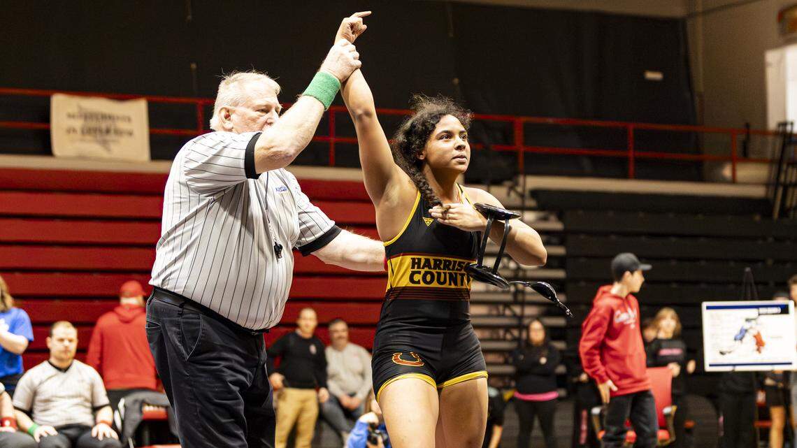 Harrison County’s Jenny White thumps her chest as she looks to her supporters in the stands after winning the 145 finals at the KHSAA Girls Region 3 Wrestling Championships at Robert D. Campbell Jr. High in Winchester on Saturday.