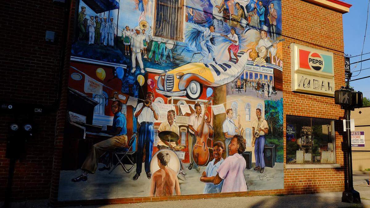 A mural on the side of Al’s Bar at the corner of West Sixth and North Limestone streets celebrates the area’s heritage of black music. The bar has just changed hands.