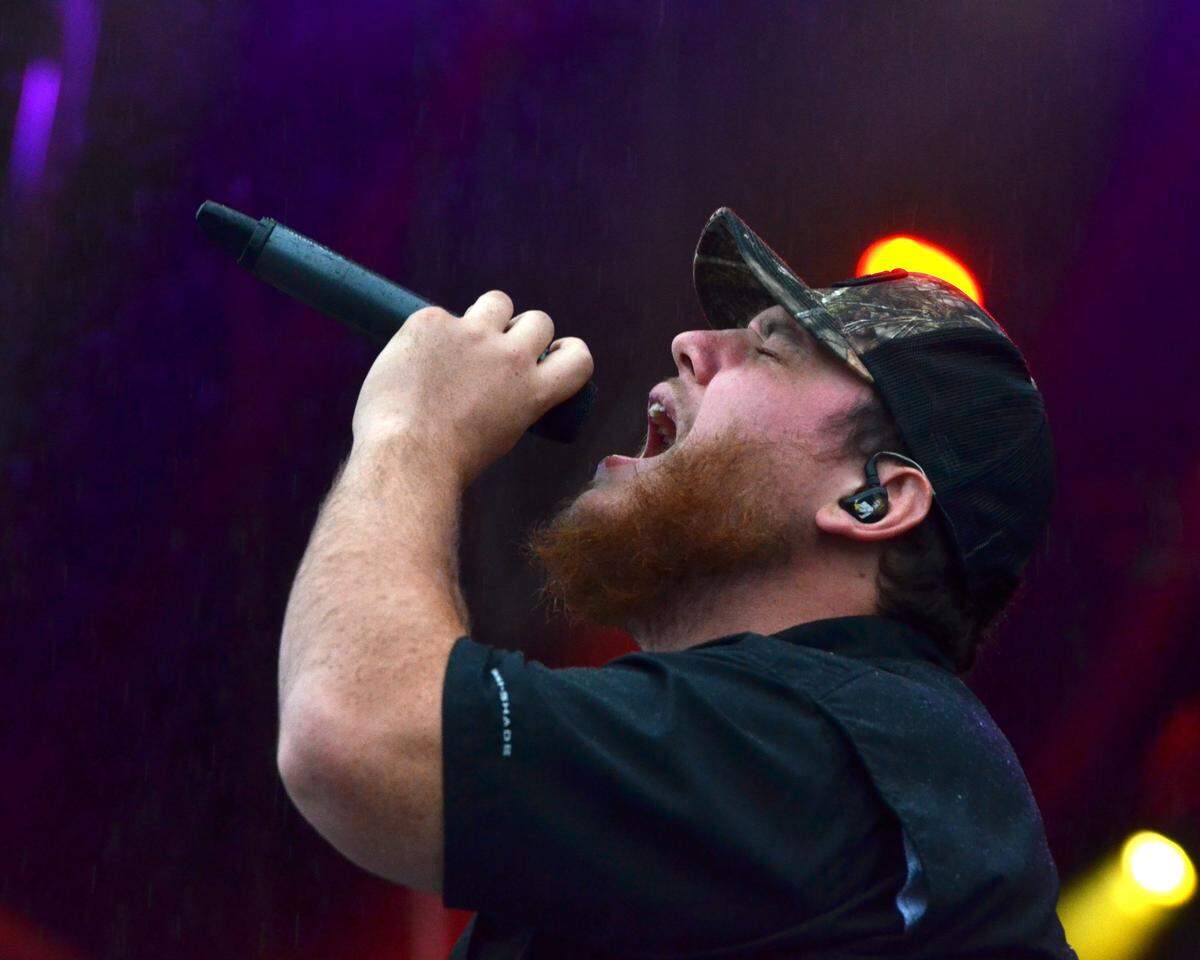 Luke Combs sings to the rain-soaked crowd the first day of Red, White & Boom 2017. He'll be back for the final night of the 2018 edition in Rupp Arena.
