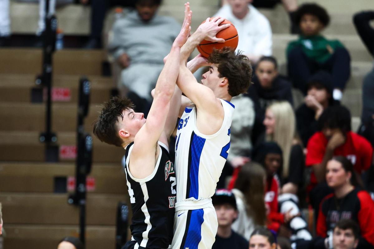 Frederick Douglass’ Logan Busson (24) defends against Lexington Catholic’s Max Meagher (24) during the 11th Region Tournament semifinals at Paul Laurence Dunbar High School’s S.T. Roach Sports Center on Saturday.