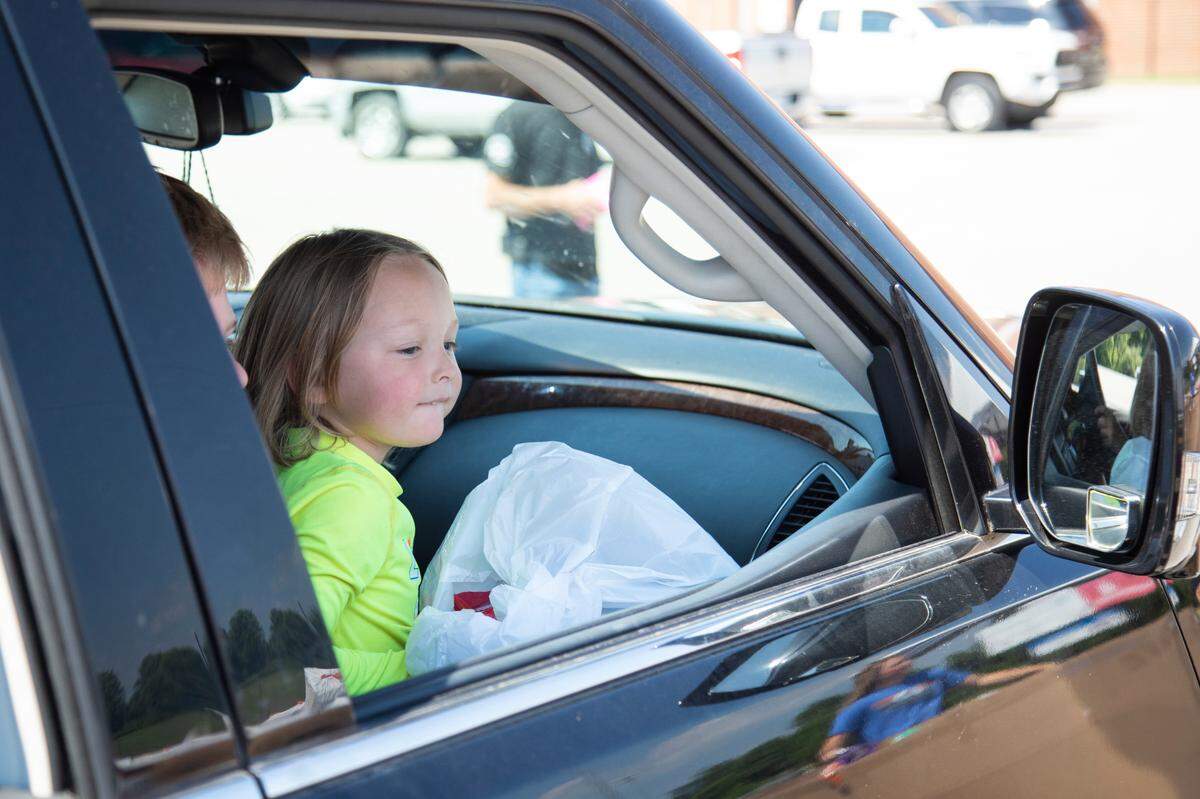 Kace Nezbeth, 4, smiles after receiving a bag of toys from the Christian Appalachian Project a giveaway at Lawrence County High School in Louisa, Ky., Thursday, June 24, 2021.