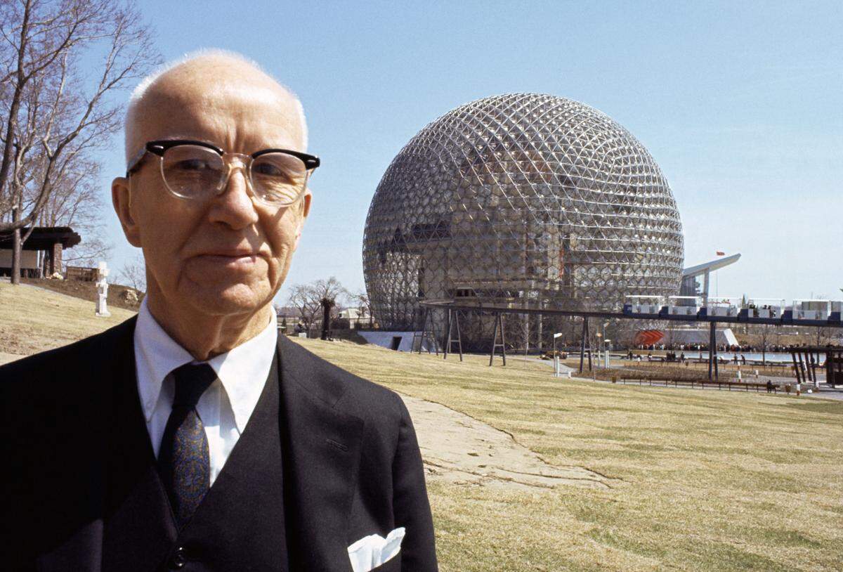 Buckminster Fuller before his geodesic dome at Montreal World Fair.