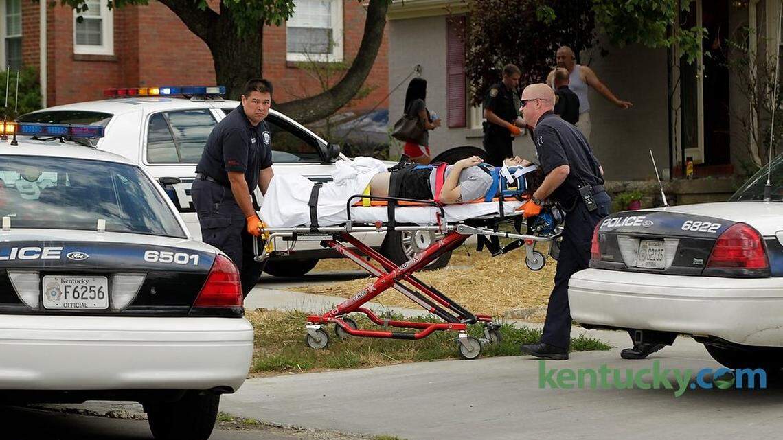 Lexington firefighters took a patient to an ambulance from a double shooting at apartment building in Coburn Boulevard in Lexington on July 16, 2014. Photo by Pablo Alcala | Staff