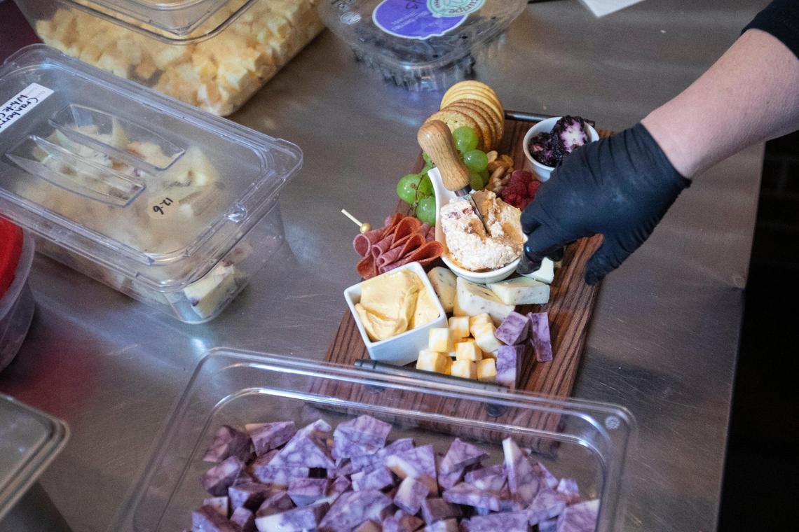 Shellie Hancock prepares charcuterie boards at the Board Room Charcuterie and Wine in Morehead.