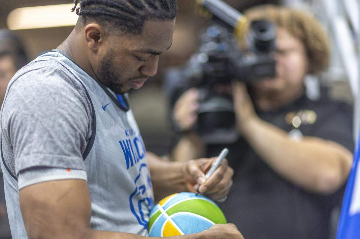 Kentucky forward Mouhamed Dioubate (23) autographed a basketball following UK’s open practice Thursday at Enterprise Center in St. Louis. Dioubate and the No. 7 seed Wildcats open play in March Madness Friday against No. 10 seed Santa Clara.