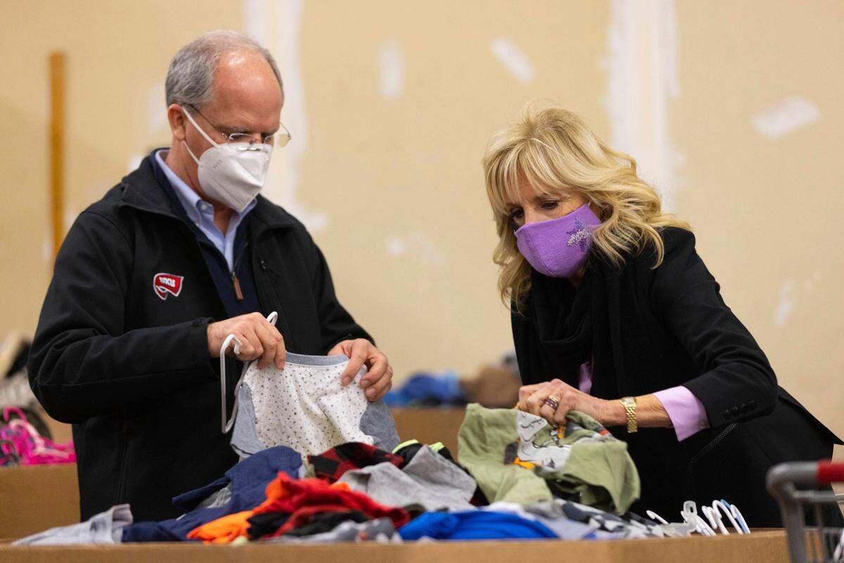 First lady Jill Biden, right, and Kentucky Rep. Brett Guthrie, left, sort children’s clothes at the FEMA State Disaster Recovery Center after a tornado in Bowling Green, Ky., Friday, Jan. 14, 2022. The Bowling Green neighborhood was one of several areas hard hit by Dec. 10 tornadoes that tore through the western part of Kentucky. (AP Photo/Michael Clubb)