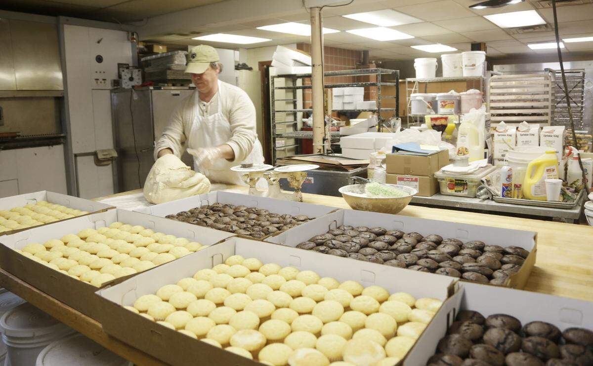 Fred Wohlstein owner of Donut Days made salt risen loaves of bread while a large order of cupcakes waited to be picked up at their Southland Dr. location in Lexington, Ky., on March 5, 2015.