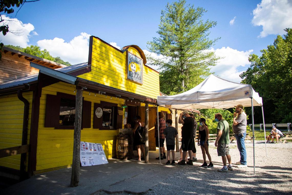 Customers line up out the front door of Miguel’s Pizza July 14 in Slade.