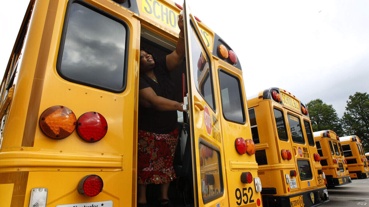 Mary Jones, who has been a bus monitor for 12 years, cleaned one of the back windows of her bus Tuesday at Fayette County Public Schools' bus garage on Liberty Road. The 2011-12 school year starts Thursday for students; teachers returned to work on Tuesday.  