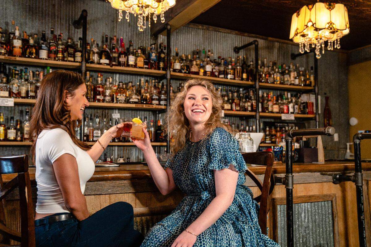 Two cocktail enthusiasts toast the opening of the Volstead Bourbon Lounge in Bardstown.