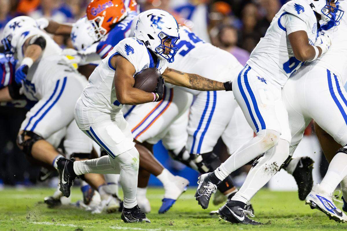 Oct 19, 2024; Gainesville, Florida, USA; Kentucky Wildcats running back Jamarion Wilcox (10) rushes with the ball against the Florida Gators during the first half at Ben Hill Griffin Stadium. Mandatory Credit: Matt Pendleton-Imagn Images