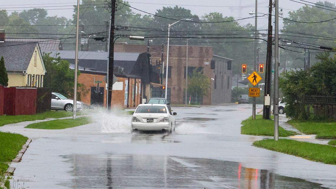 A car drives through standing water during a rush-hour rainstorm on Southview Drive, Friday, May 30, 2025 in Lexington, Ky.