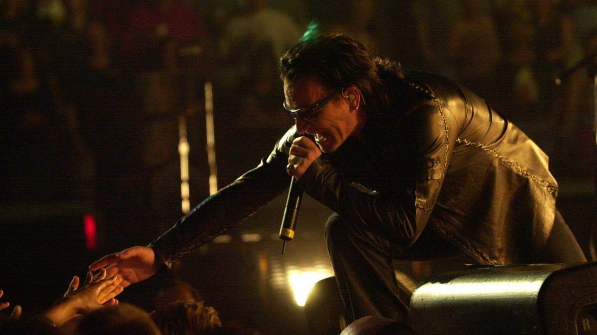 Derby Eve, 20 years ago: Bono, lead singer to the band U2, reached out and touched some hands at their performance at Rupp Arena in Lexington Ky., May, 4, 2001.