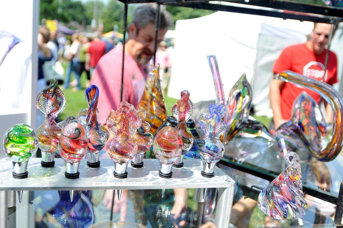 Hayesville, N.C. glass artist Mark Goldhagen talks to customers in his booth at the Woodland Art Fair. The 38th annual Woodland Art Fair, presented by the Lexington Art League, was Aug. 17 and 18, 2013, at Woodland Park in Downtown Lexington, Ky. Photo by Rich Copley | staff.