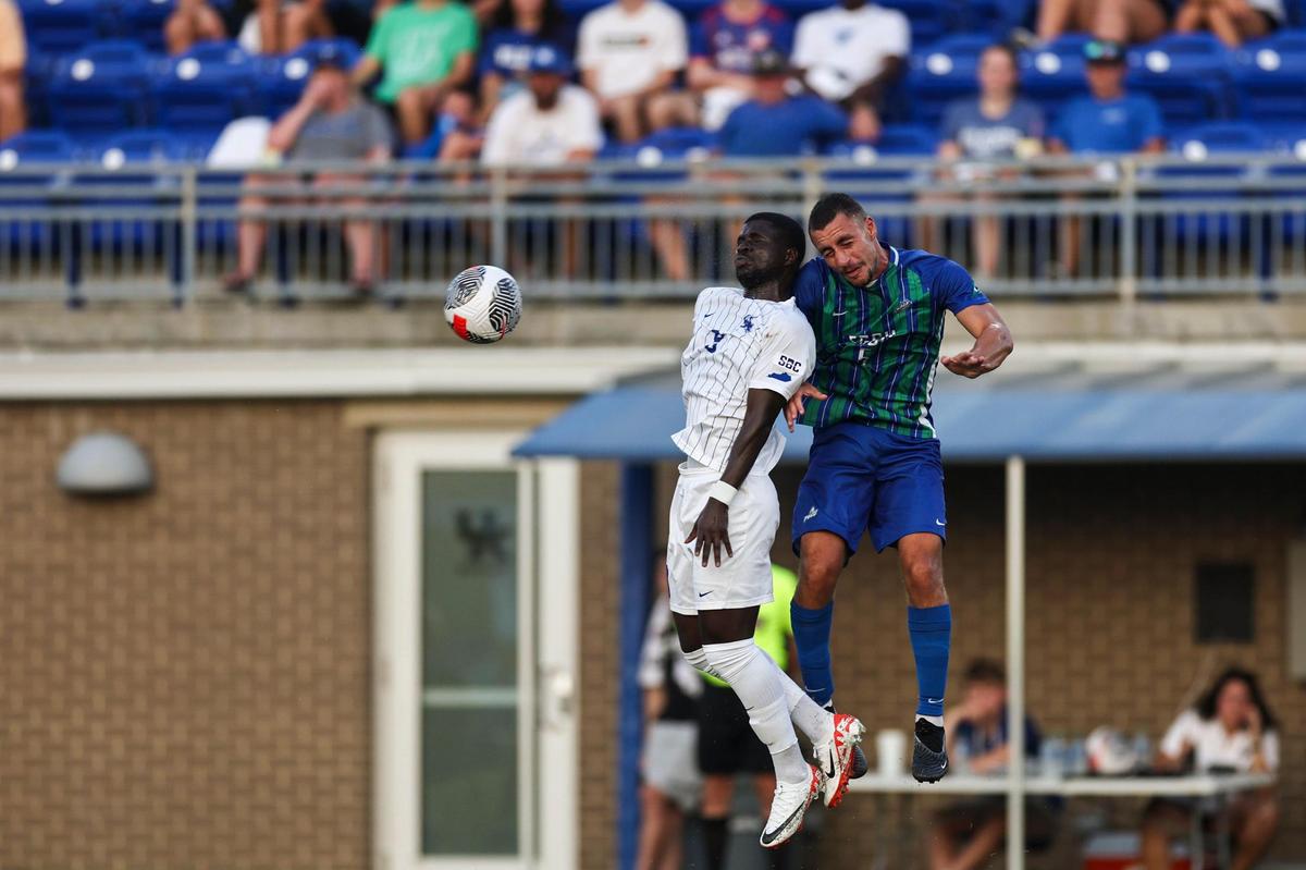 Kentucky senior forward Aboubacar Camara, left, jumps to contest a ball during a match against Florida Gulf Coast at the Wendell & Vickie Bell Soccer Complex on Aug. 24. Camara previously played three seasons at Louisville and scored 25 goals for the Cardinals.