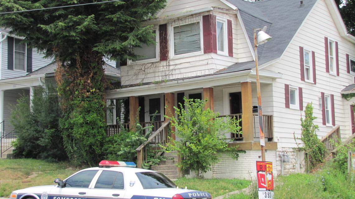 Somerset attorney Mark Stanziano was shot and killed outside his office early on 6/27/2014. Police quickly arrested Clinton Inabnitt, who lived across the street from Stanziano's office in an apartment in this house. Here, a Somerset police car sits outside the apartment house. 6/27/2014 photo by Bill Estep